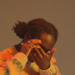 Model wears Dome / Emerald Ring on middle finger alongside other featured jewelry