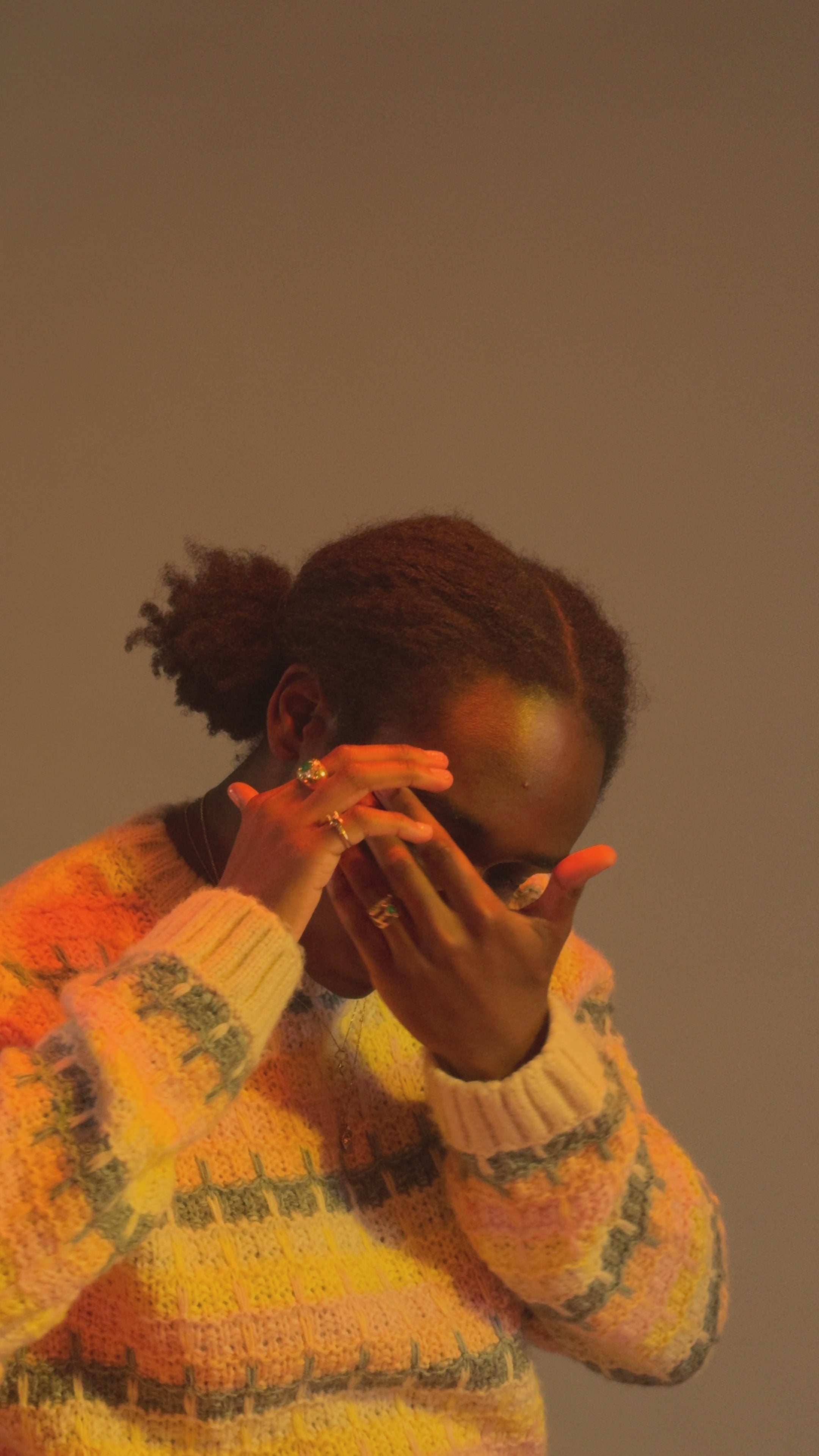 Model wears Dome / Emerald Ring on middle finger alongside other featured jewelry