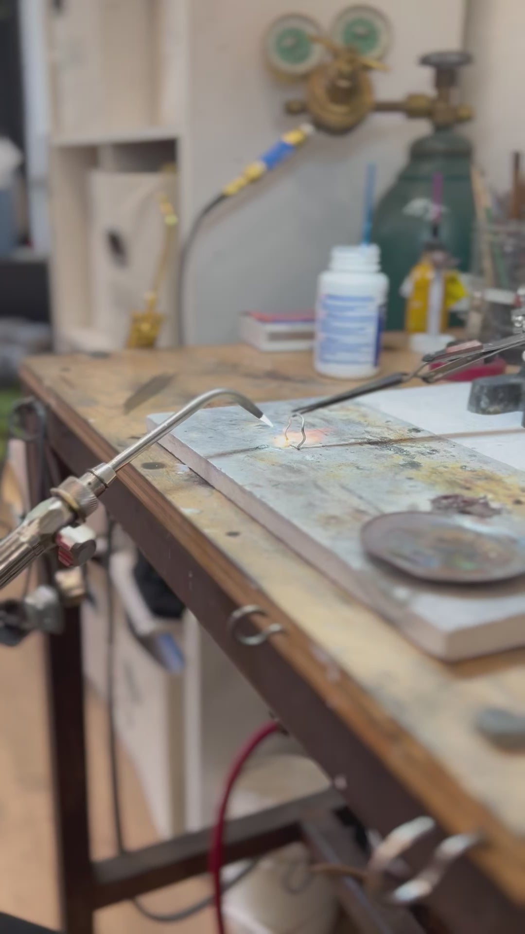 Student using blowtorch to create a ring during a private workshop