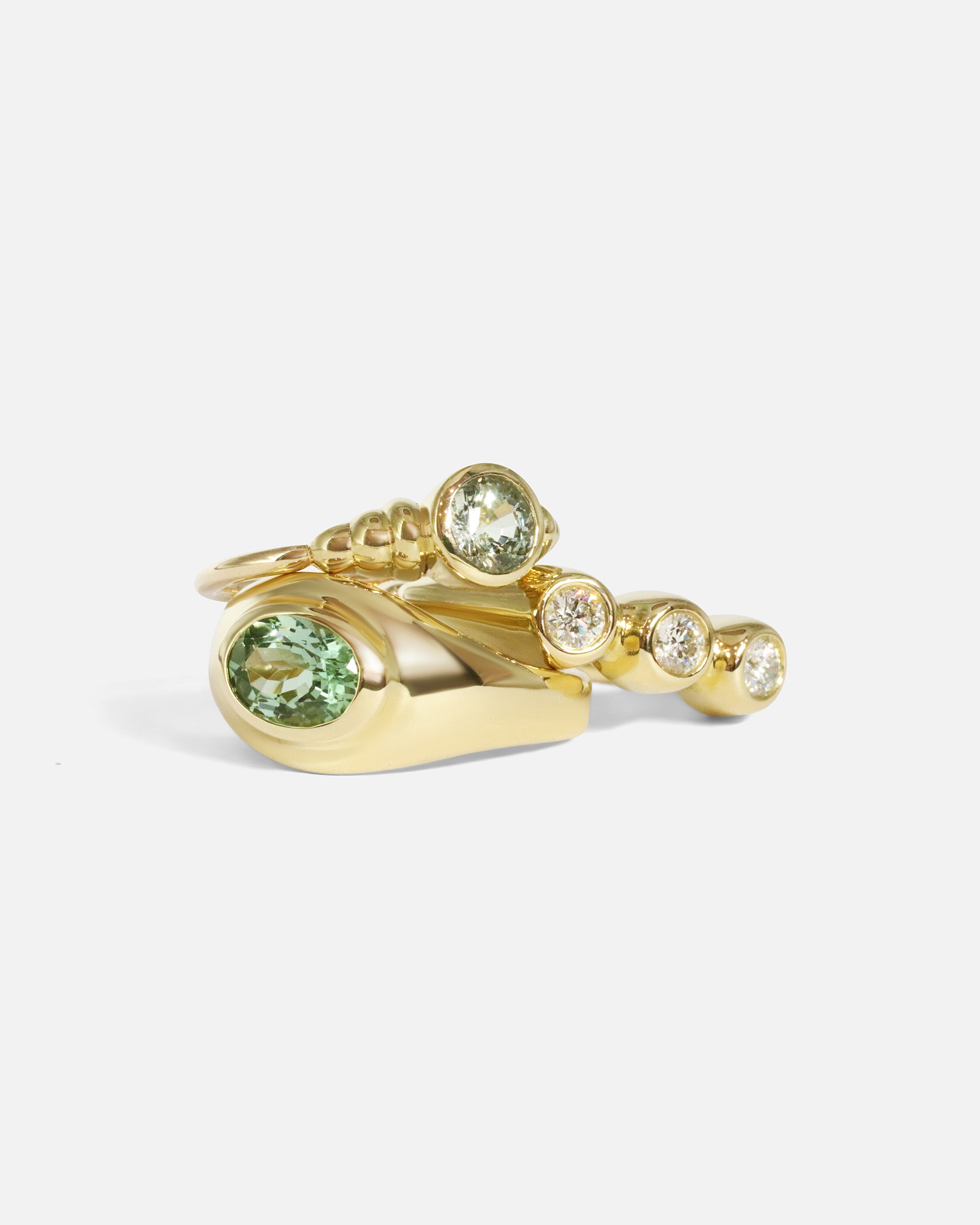 Stacked view of Belle Ring in 14k yellow gold, Easy Ring in 14k yellow gold, and Hunny Ring in 14k yellow gold by tmrw days 