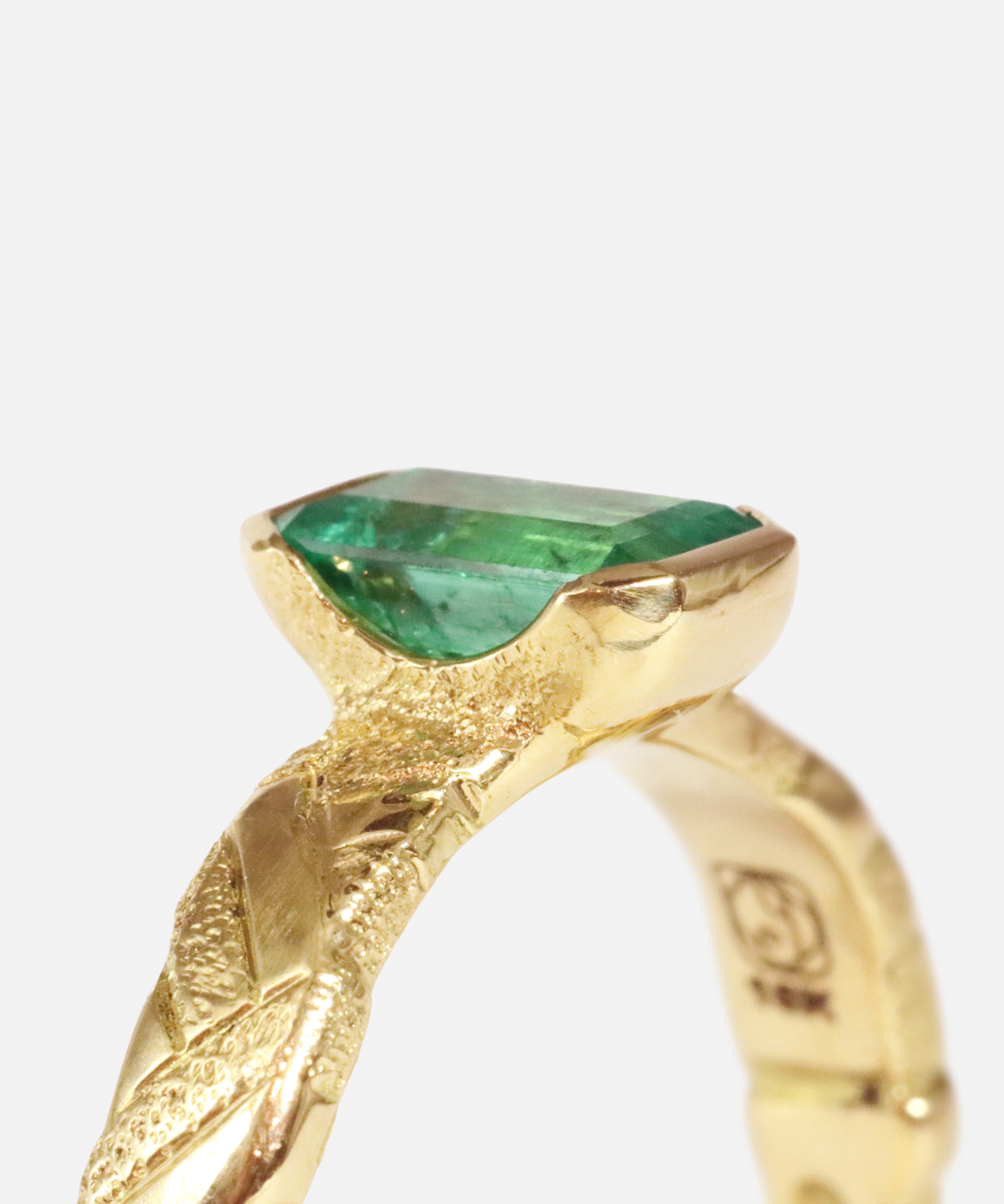 Close up angled side profile view of Paths / Columbian Emerald Ring by Young Sun Song