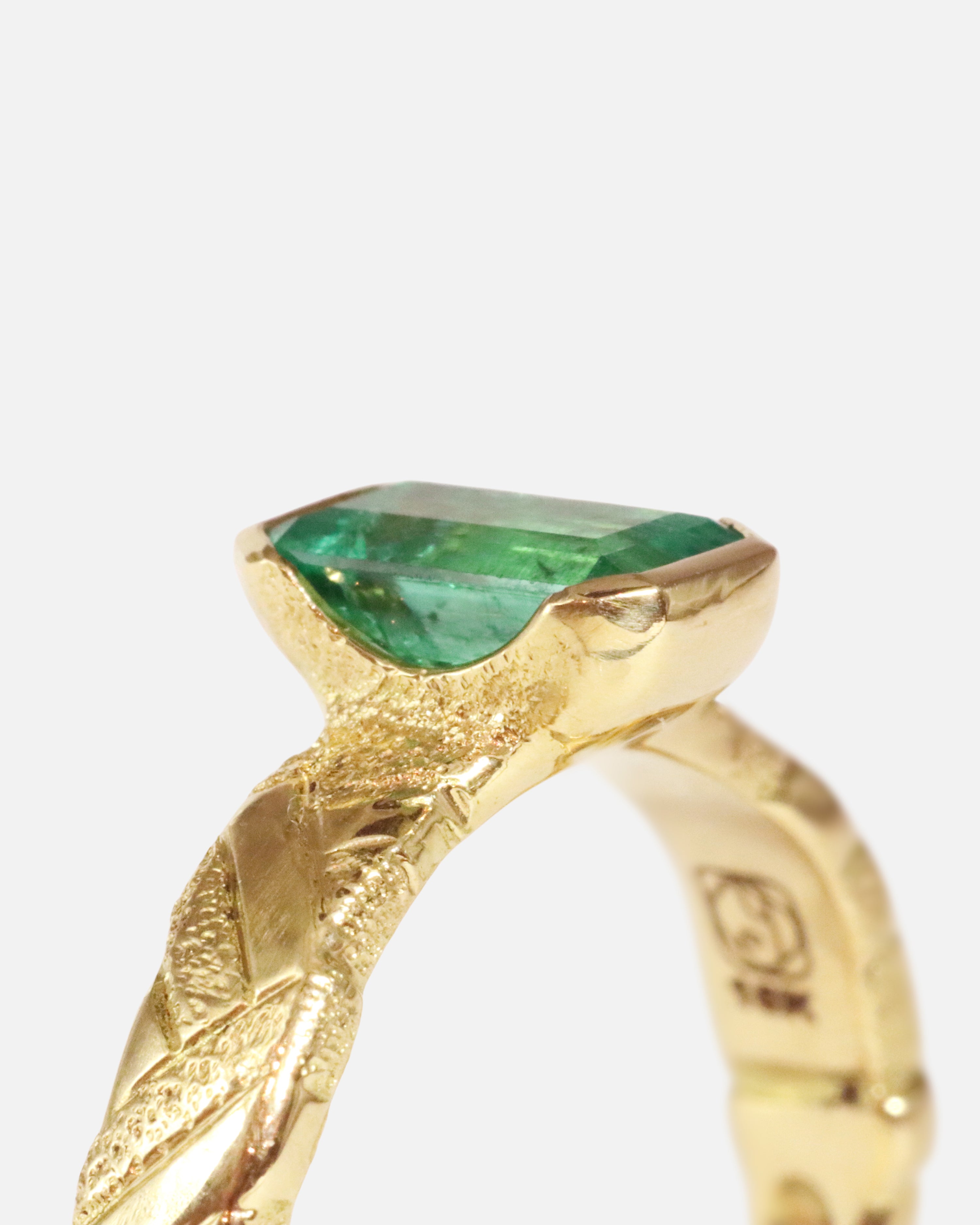 Close up angled side profile view of Paths / Columbian Emerald Ring by Young Sun Song