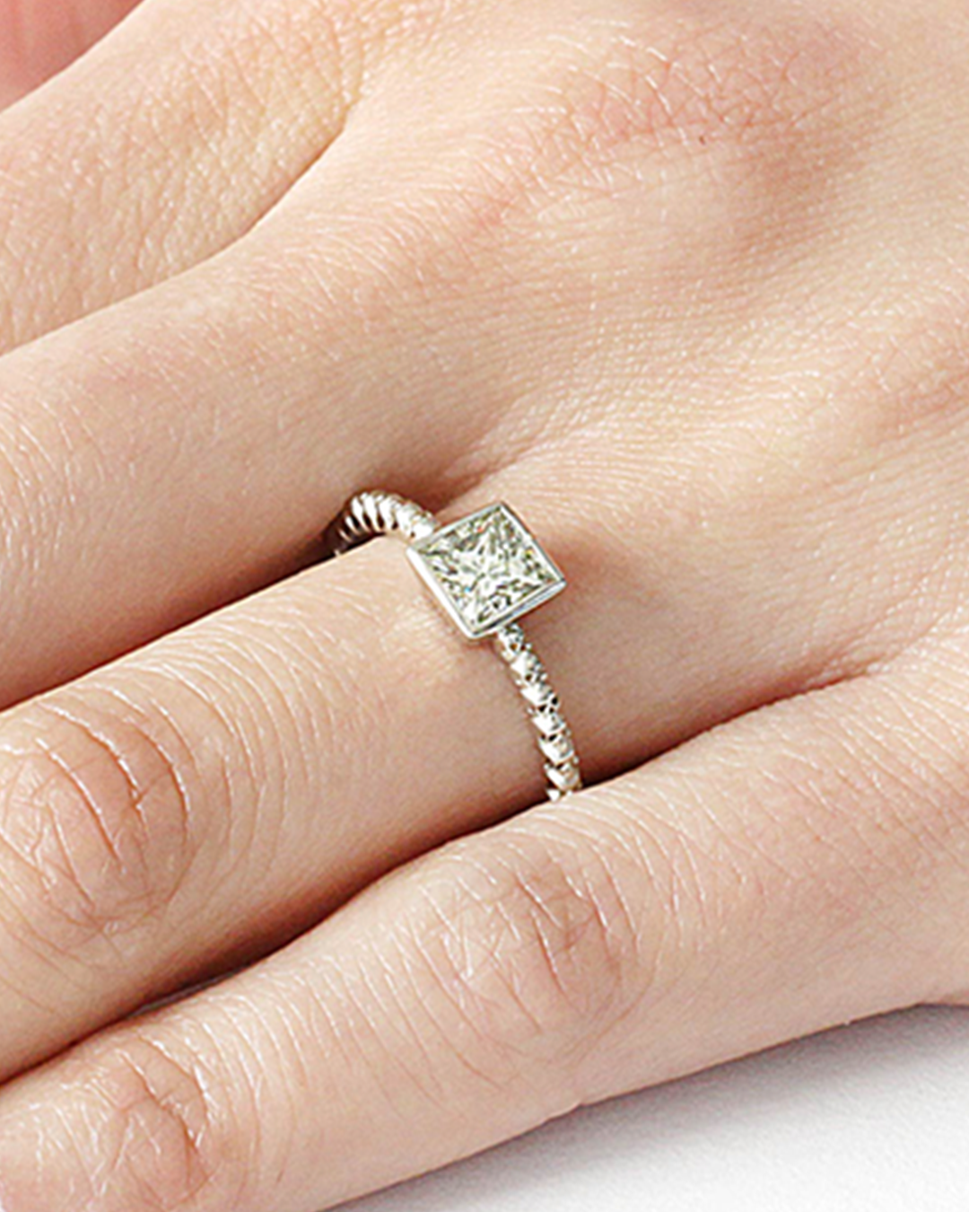Model wears Square Bezel Skull Shank / White Diamond on ring finger