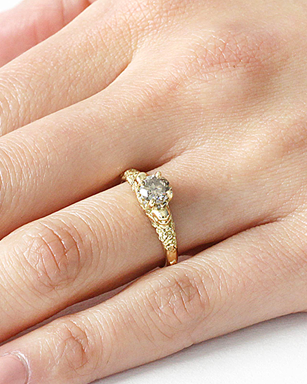 Model wears Skull and Flower Halo / Grey Diamond on ring finger