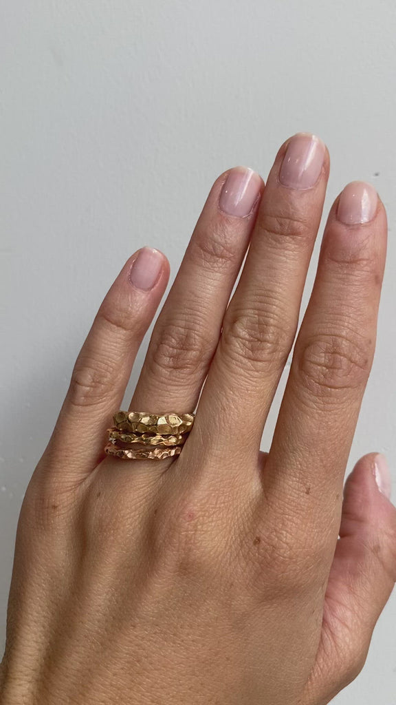 Model wears various widths of the Rough Water Band by O Channell Designs on ring finger