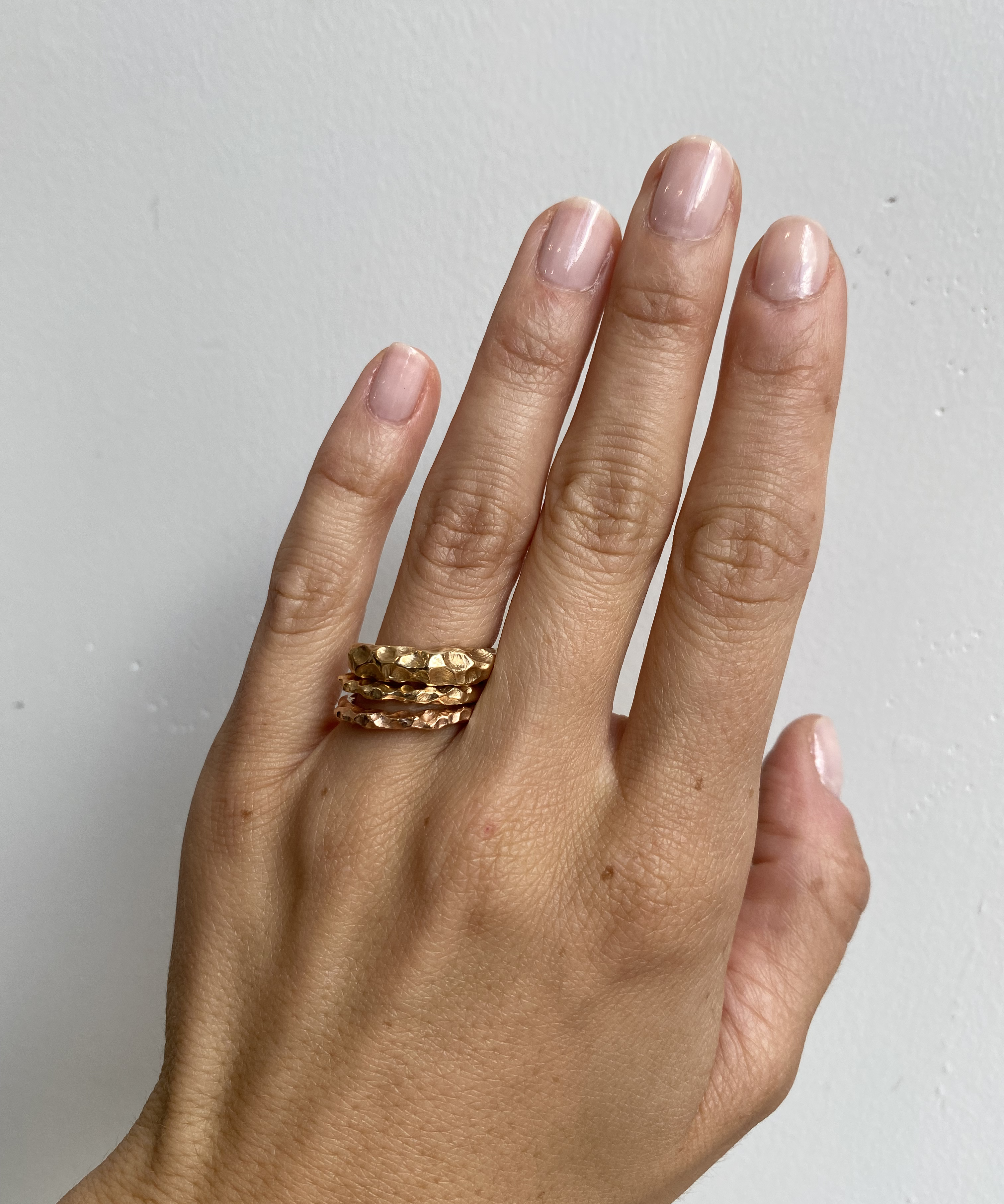 Model wears Rough Water Band in various widths on ring finger By O