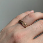 Model wears Rose Garden Band in 18k rose gold on ring finger